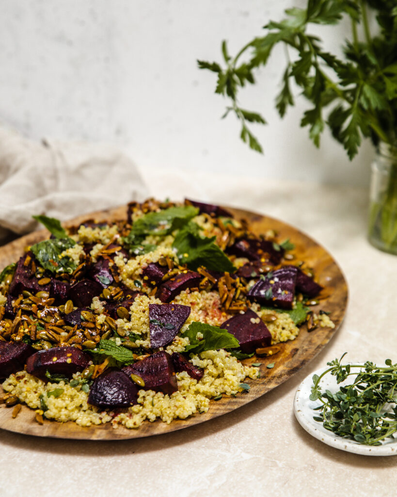 Beetroot, maple quinoa crunch and mint on a wooden serving board