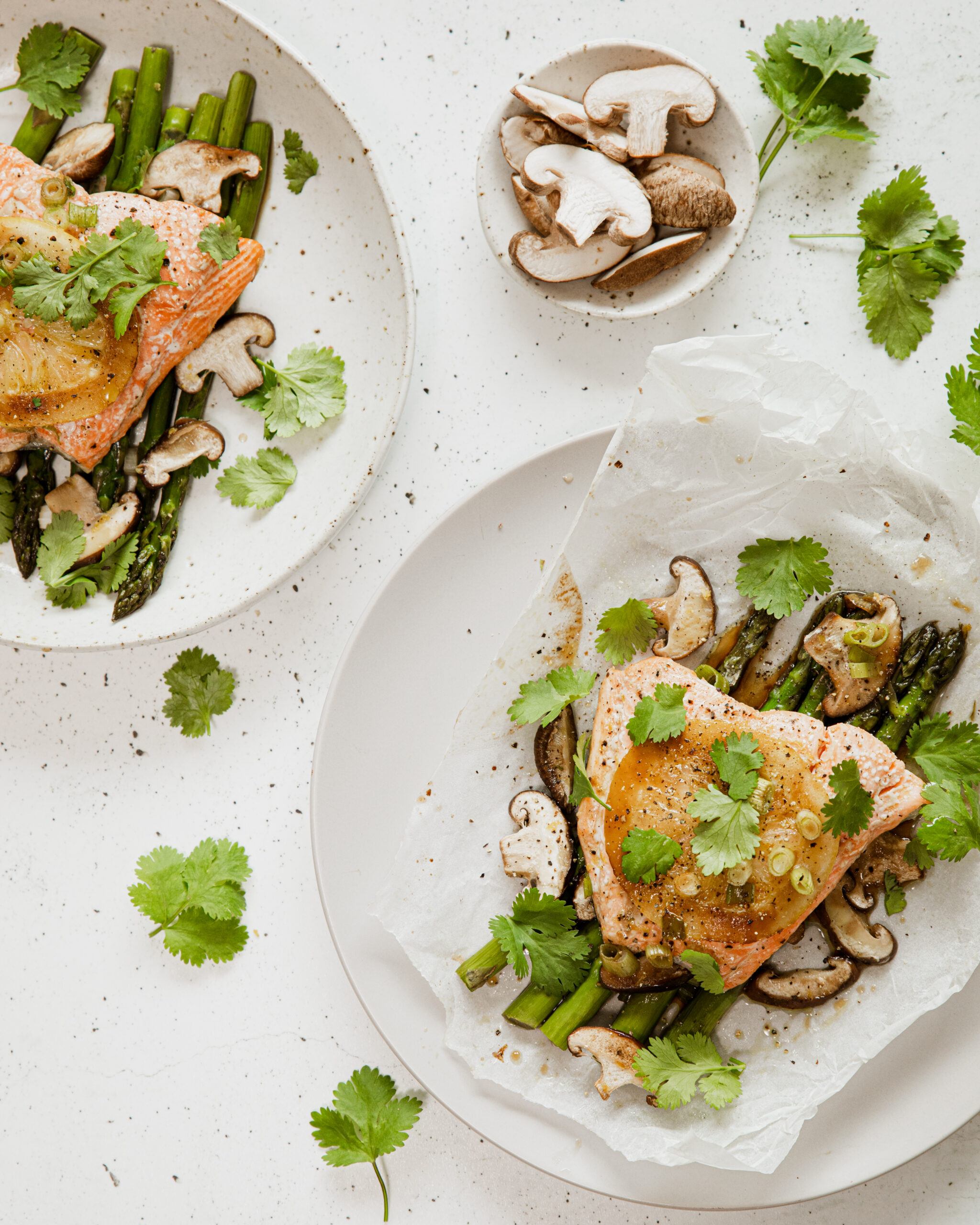 Baked paper topped with salmon, asparagus and mushrooms