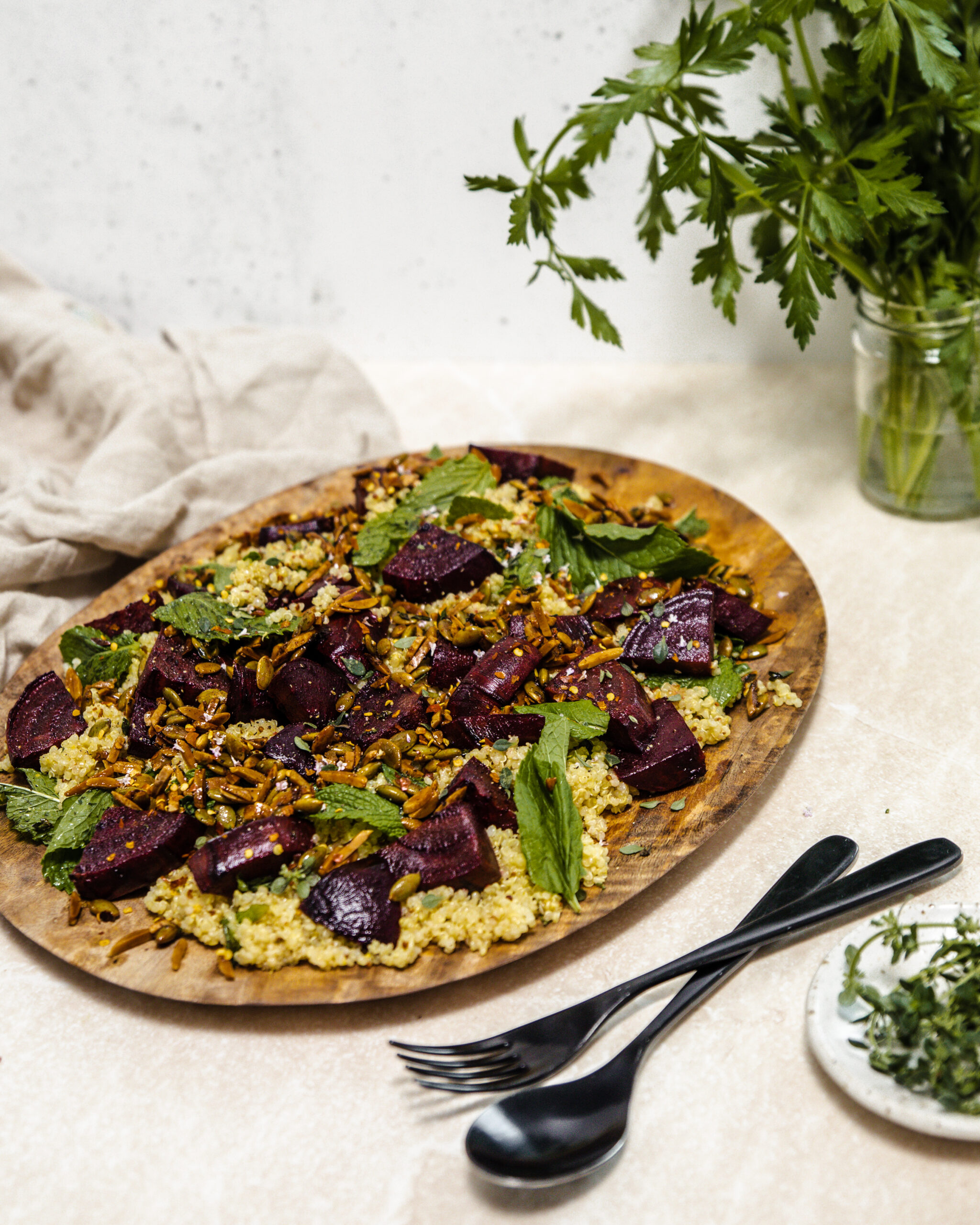 Beetroot, mint and maple crunch quinoa on a wooden serving board
